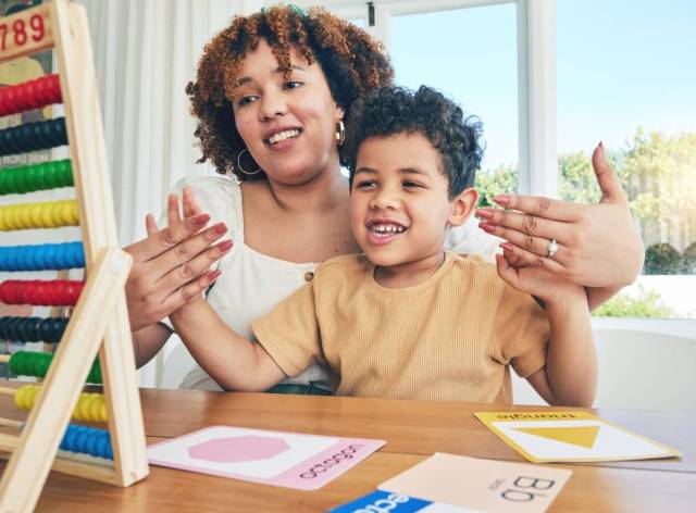 Mother teaching her son basic math skills to prepare him for school