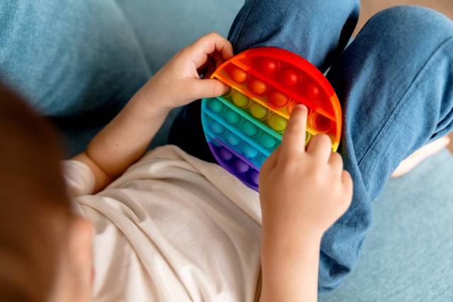 A child playing with a sensory toy
