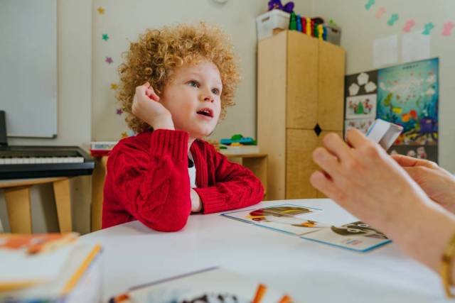 Boy on the session of speech therapist