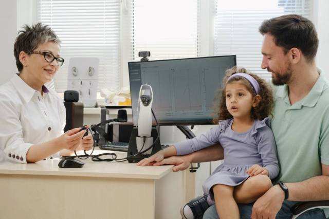 Doctor conducting a child hearing test to examine hearing dyslexia