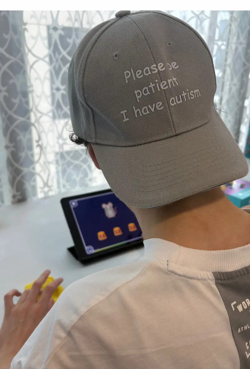 Child with autism engaged independently with Magrid visual cognitive learning on a tablet at home