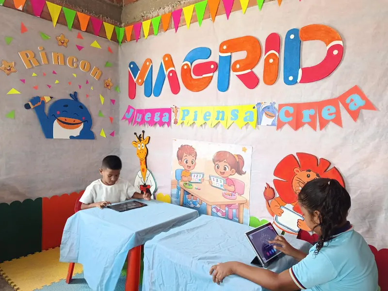 Children using Magrid's visual cognitive development method on tablets at a dedicated Magrid learning corner in Latin America